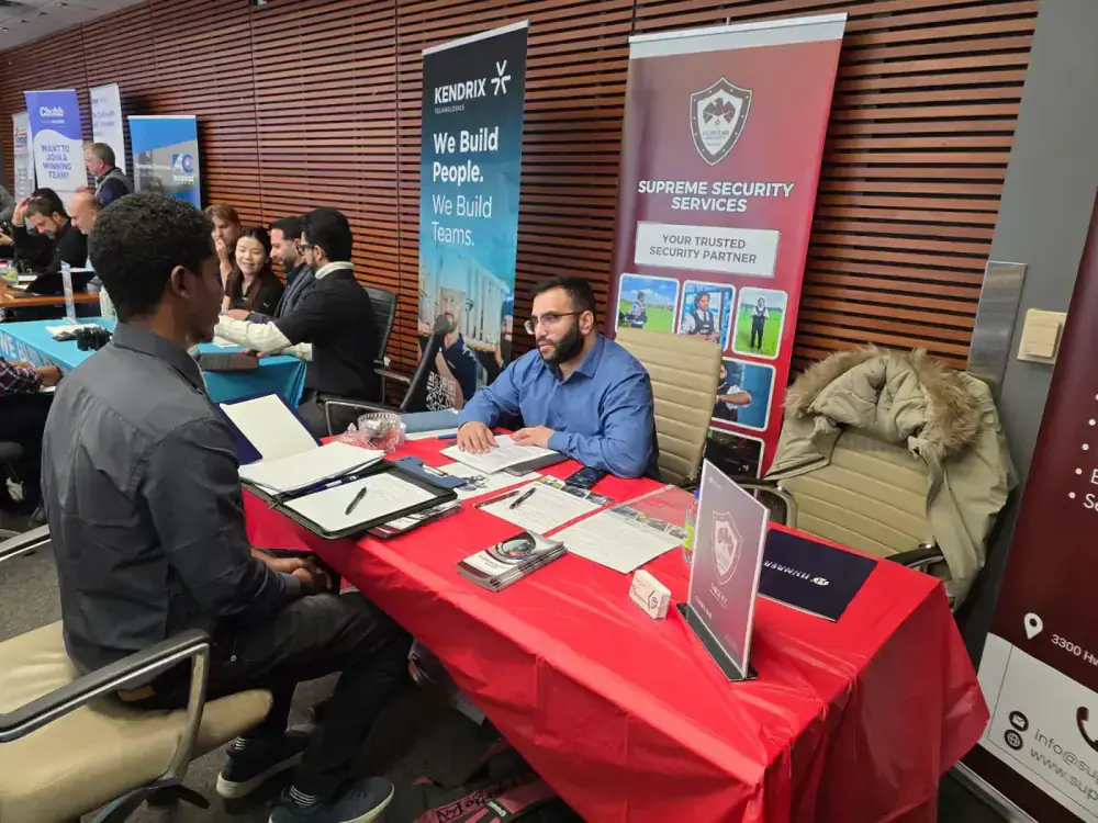 Supreme Security recruiter interviewing a candidate at a security careers hiring event